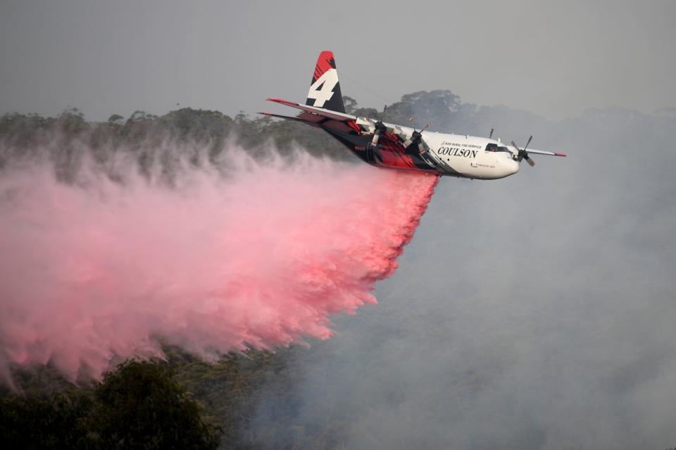 The NSW RFS Large Air Tanker drops fire retardant in the NSW Southern Highlands during the Australian bushfires