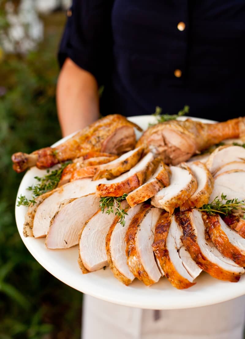 Sliced grilled turkey with thyme on a plate