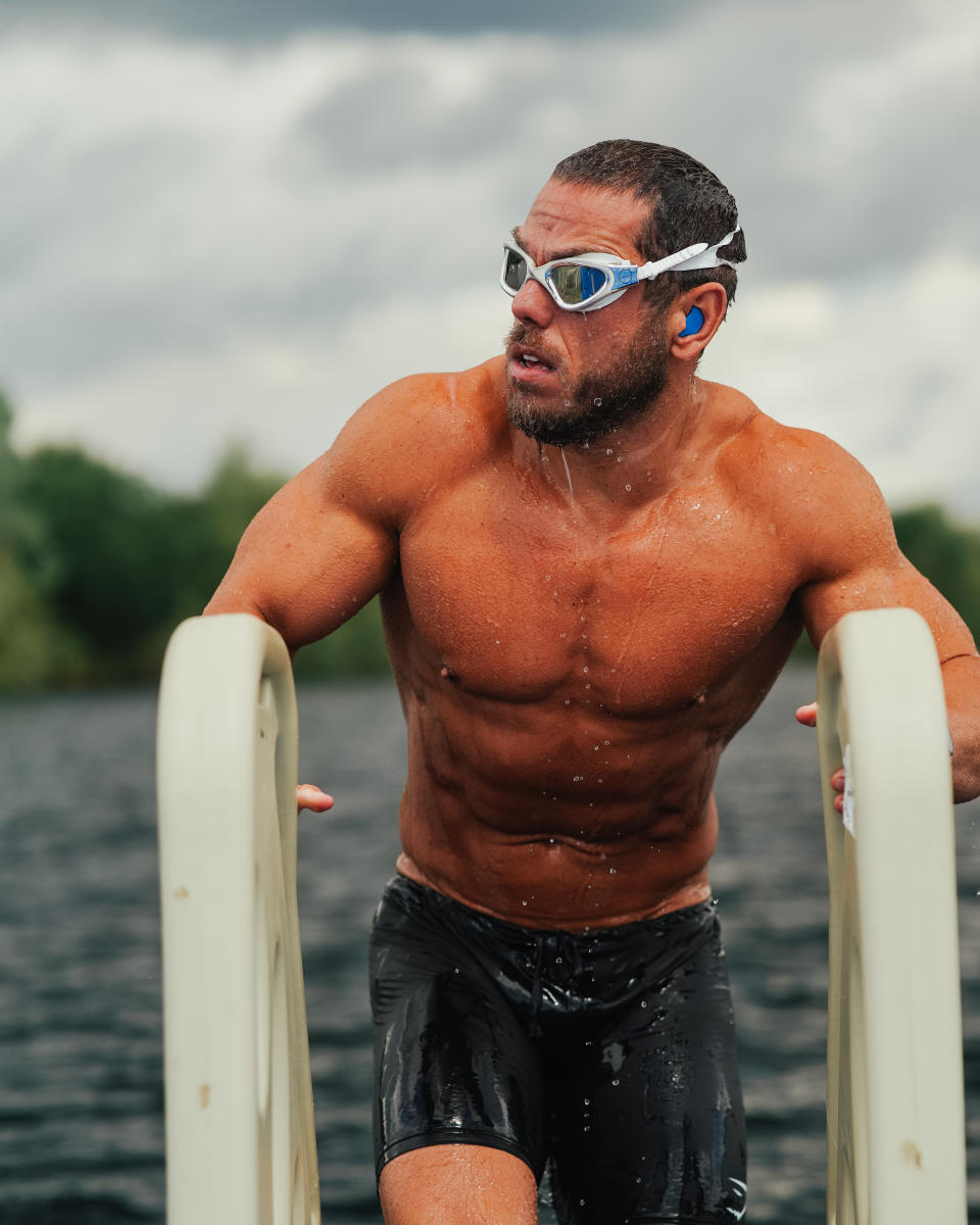 Man exits water after swimming