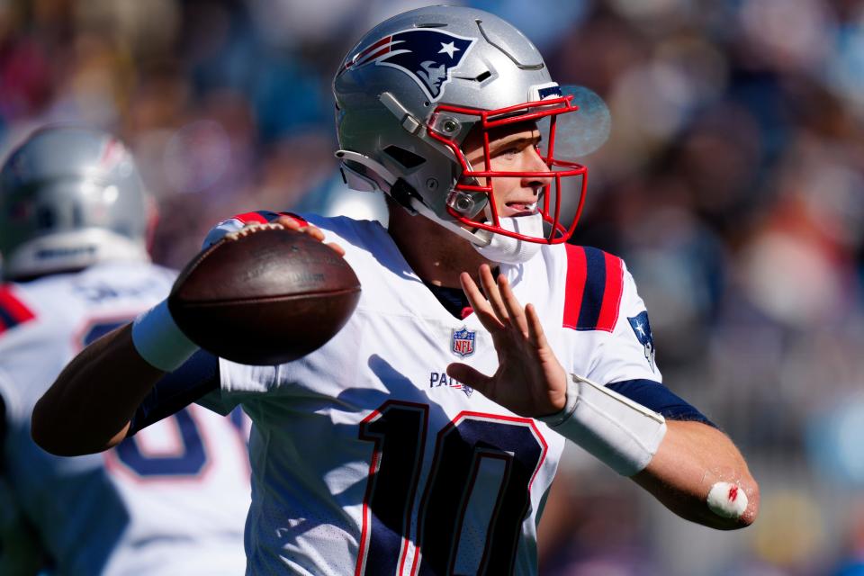New England Patriots quarterback Mac Jones passes during the first half of an NFL football game against the Carolina Panthers Sunday, Nov. 7, 2021, in Charlotte, N.C. (AP Photo/Jacob Kupferman)