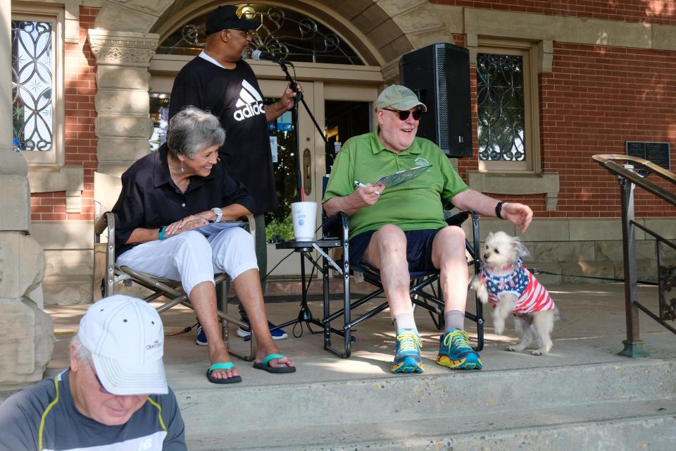 Contest judges Nancy Tanner and Ralph Duke look over young Sadie the dog as she looks to curry favor for award consideration  during the patriotic pet parade Saturday morning at the Amarillo Community Market in downtown Amarillo.