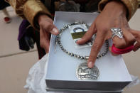 Brianne Arviso describes the Navajo historical elements in a piece of jewelry she hoped to gift to First Lady Jill Biden during Biden’s visit to the reservation Thursday, April 22, 2021 in Window Rock, Ariz. The trip is Biden’s third to the vast reservation that stretches into Arizona, New Mexico and Utah. (AP Photo/Felicia Fonseca)