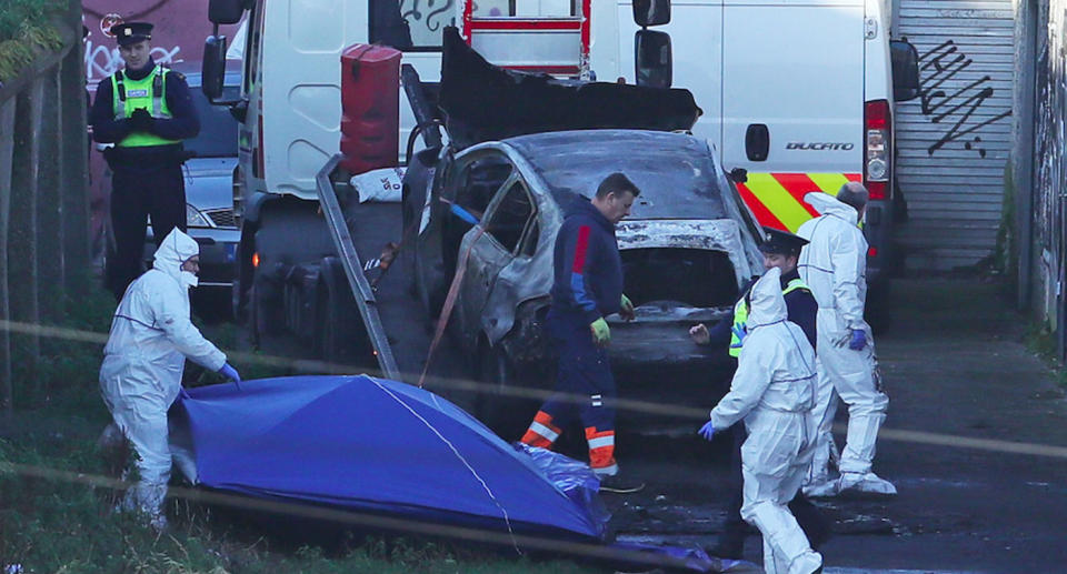 A burnt-out car on the back of a tow truck. The severed body parts of Keane Mulready-Woods were found in the car.