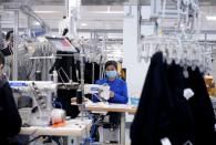 FILE PHOTO: A worker works at Xunxi factory, which is an affiliate of Chinese e-commerce giant Alibaba, during a media tour, in Hangzhou