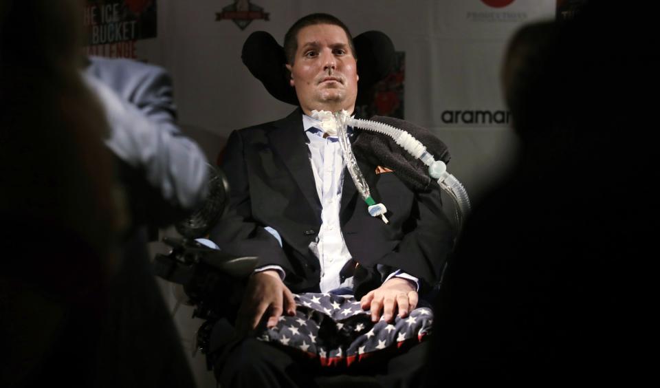FILE - In this Sept. 18, 2017 photo, Pete Frates, who is stricken with amyotrophic lateral sclerosis, or ALS, listens to a guest at Fenway Park in Boston. Frates, a former college baseball player whose determined battle with Lou Gehrig’s disease helped inspire the ALS ice bucket challenge that has raised more than $200 million worldwide, died Monday, Dec. 9, 2019. He was 34. (AP Photo/Charles Krupa, File)