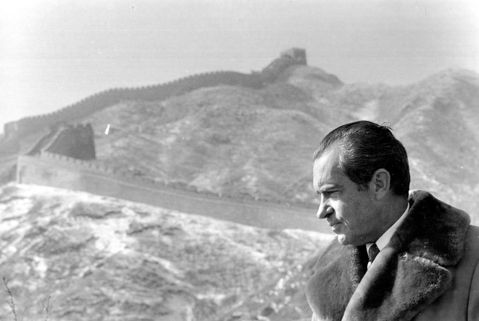 FILE - Then U.S. President Richard Nixon stands at The Great Wall of China, which snakes over the mountain behind him, near Beijing on Feb. 24, 1972. At the height of the Cold War, U.S. President Richard Nixon flew into communist China's center of power for a visit that over time would transform U.S.-China relations and China's position in the world in ways that were unimaginable at the time. (AP Photo, File)