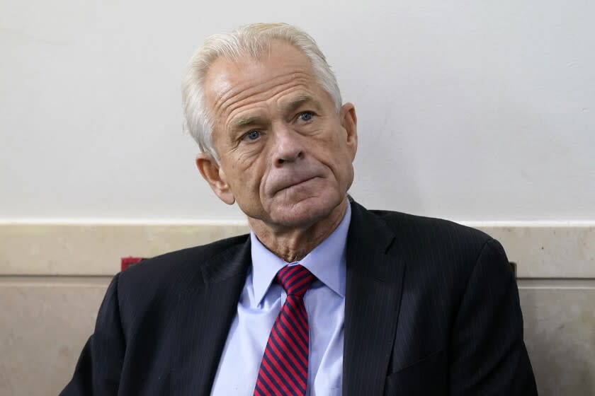 FILE - White House trade adviser Peter Navarro listens as President Donald Trump speaks during a news conference at the White House, on Aug. 14, 2020, in Washington. Former Trump adviser Navarro revealed in a draft court filing Tuesday, May 31, 2022, that he has been subpoenaed to appear before a grand jury this week as part of the Justice Department's sprawling probe into the deadly insurrection at the U.S. Capitol. (AP Photo/Patrick Semansky, File)