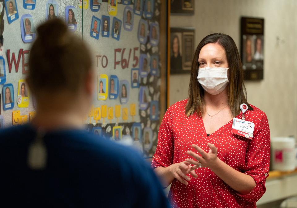 Nurse Sara Schoen leads a huddle with her staff at UW Hospital in Madison on May 6.