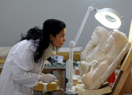 A specialist works on a damaged statue from Palmyra at Syria's National Museum of Damascus, Syria January 9, 2019. Picture taken January 9, 2019. REUTERS/Omar Sanadiki