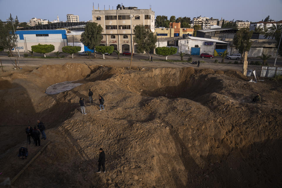 Palestinians inspect damage from overnight Israeli airstrikes in Gaza City, Friday, April 7, 2023. The Israeli military has struck targets in the Gaza Strip, pushing the region toward a wider conflagration after a day of rocket fire along the country's northern and southern borders. The fighting follows two days of unrest at Jerusalem's most sensitive holy site. As Israeli aircraft began striking Gaza, Palestinian militants quickly fired off a new barrage of rockets, setting off air raid sirens across southern Israel. (AP Photo/Fatima Shbair)