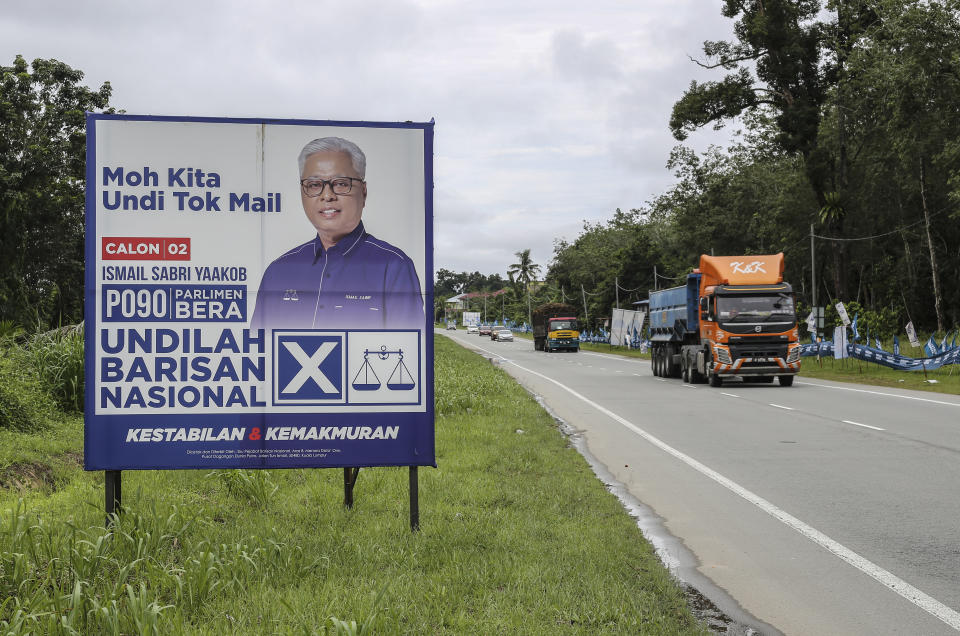 Poster of Malaysian caretaker Prime Minister Ismail Sabri Yaakob is installed along the road for election campaign for the upcoming general election in Bera, Pahang, Malaysia, Saturday, Nov. 18, 2022. The Nov. 19 election will determine if Barisan Nasional, or National Front, can make a strong comeback or whether political reformers can secure another surprise win that will see their leader, Anwar Ibrahim, achieve a long-held dream of becoming prime minister.(AP Photo/Ahmad Yusni)