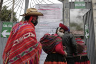 Voters wearing masks to curb the spread of COVID-19 line up at a polling post during general elections in Ollantaytambo, Peru, Sunday, April 11, 2021. (AP Photo/Sharon Castellanos)