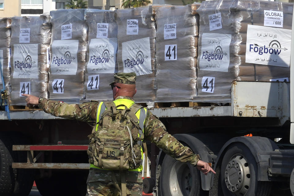 A U.S. soldier stands as Gaza aid on a truck is about to enter a U.S ship, at the port of Larnaca, Cyprus, Wednesday, June 26, 2024. An official with the U.S. humanitarian assistance agency USAID says thousands of tons of food, medicines and other aid piled up on a Gaza beach isn't reaching those in need because of a dire security situation on the ground where truck drivers are either getting caught in the crossfire or have their cargo seized by "gang-like" groups. (AP Photo/Petros Karadjias)