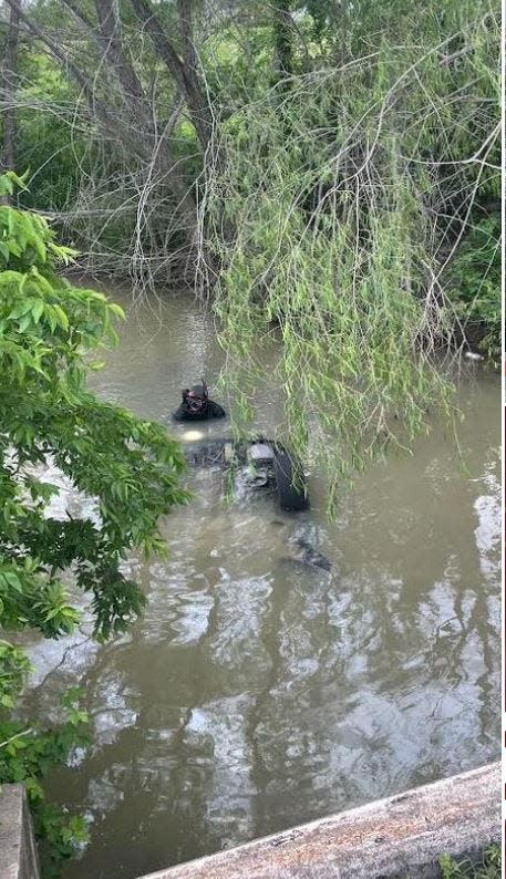 Rescue crews found a car submerged in a creek off Cameron Road in Manor on Monday morning. Officials later found a man's body inside the car.