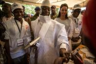 Incumbent Gambian president Yahya Jammeh (C) has his finger inked before casting his marble in a polling station in a presidential poll, in Banjul on December 01, 2016