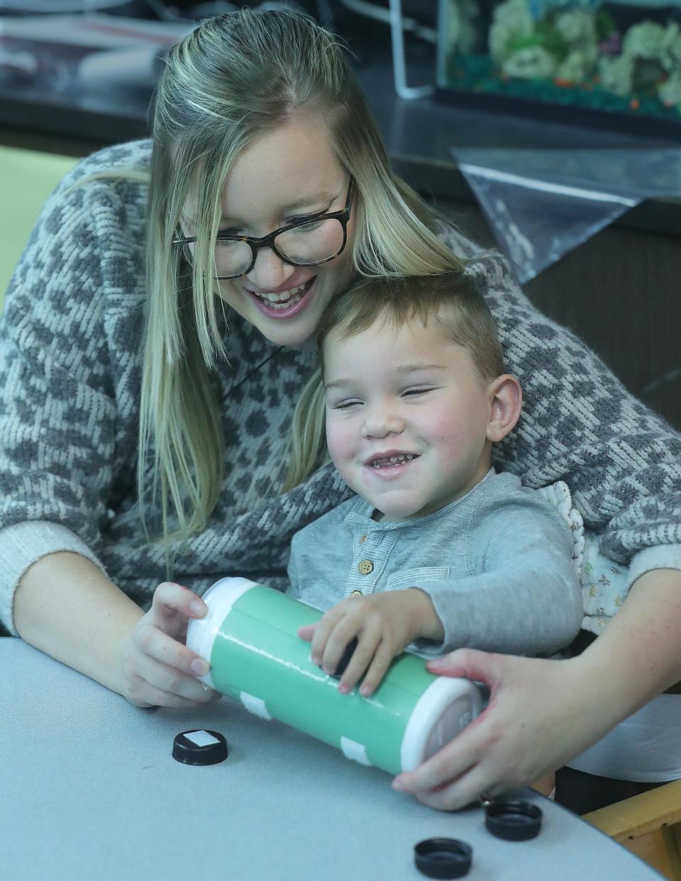 David Detwiler works on a fine motor skills exercise with his teacher, Taylor Edwards, at Eastgate Early Childhood Development Center in Louisville.