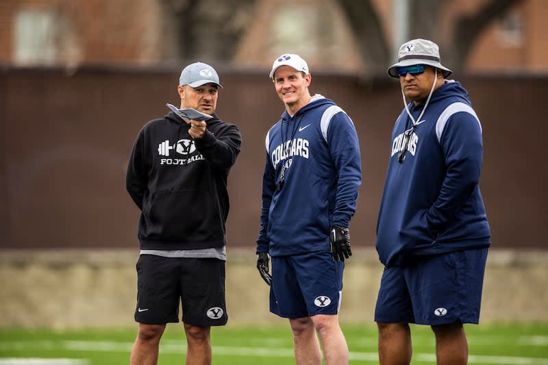 BYU passing game coordinator and wide receivers coach Fesi Sitake, talks with defensive coordinator Jay Hill and head coach Kalani Sitake during practice.