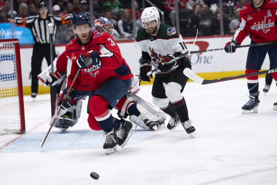 Washington Capitals defenseman Nick Jensen (3) and Arizona Coyotes left wing Jason Zucker (16) watch the puck during the second period of an NHL hockey game, Sunday, March 3, 2024, in Washington. (AP Photo/Manuel Balce Ceneta)