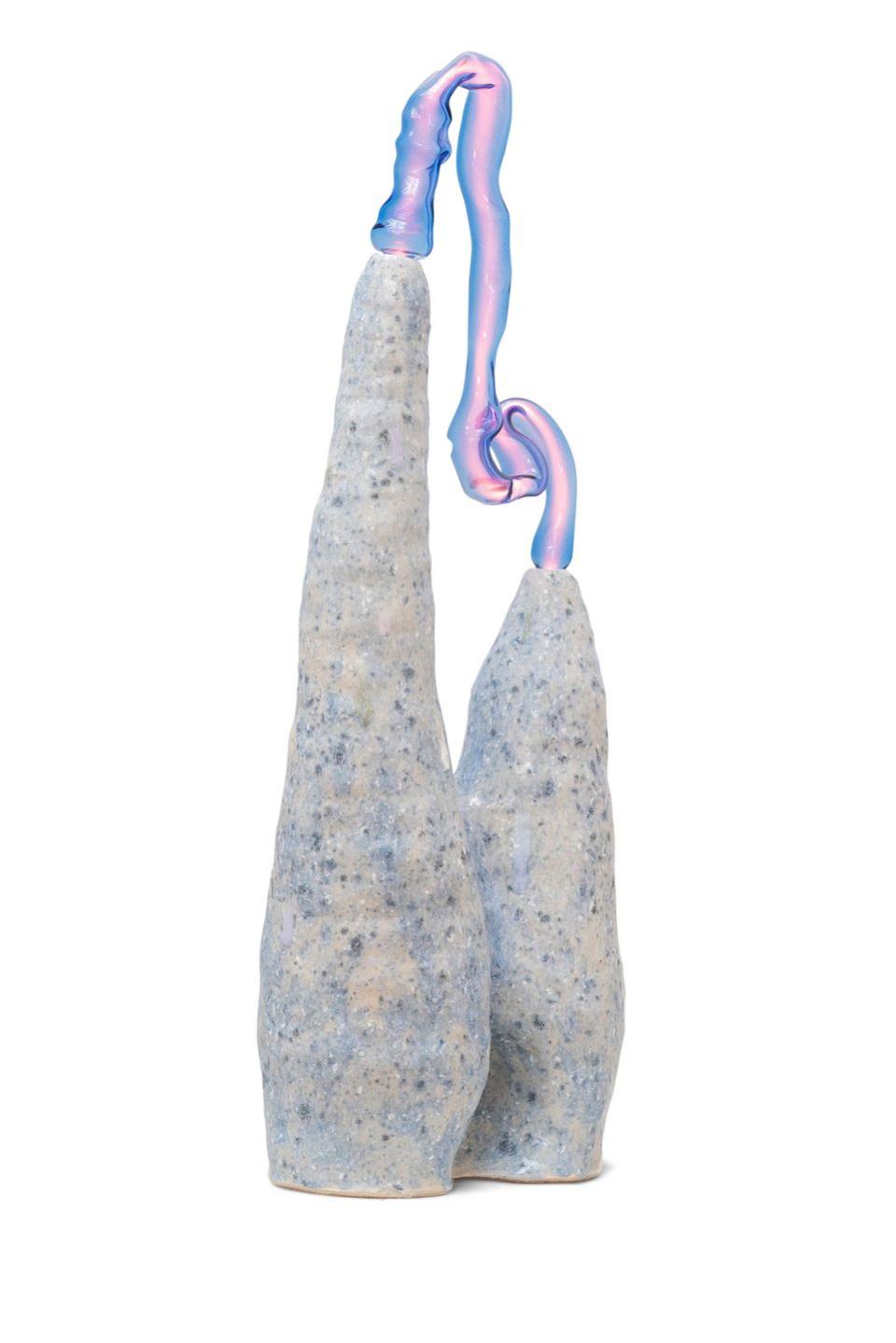 tall thin stone looking lamps with blue specks and a blue pink ribbon at top