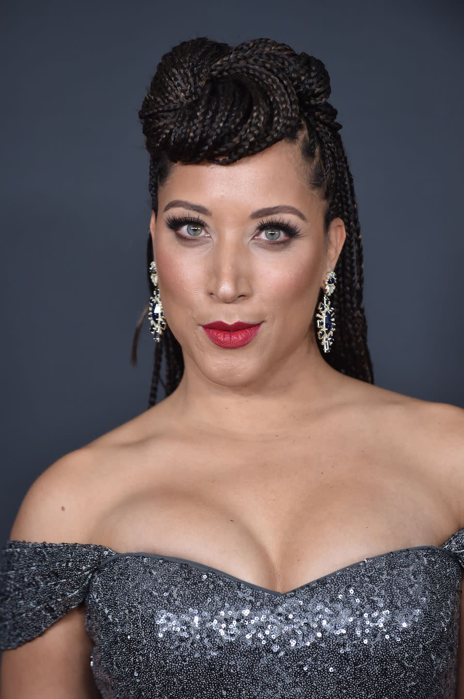 <p>Twist box braids into a spiral-like bun that sit on the crown of the head like actress Robin Thede.</p>