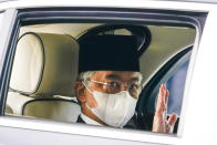 Malaysia's King Sultan Abdullah Sultan Ahmad Shah waves as he leaves National Palace in Kuala Lumpur, Malaysia, Sunday, Oct. 25, 2020. National Palace statement says Malay rulers has decided not to accede to Prime Minister Muhyiddin Yassin's request to declare a state of emergency. (AP Photo/Vincent Thian)