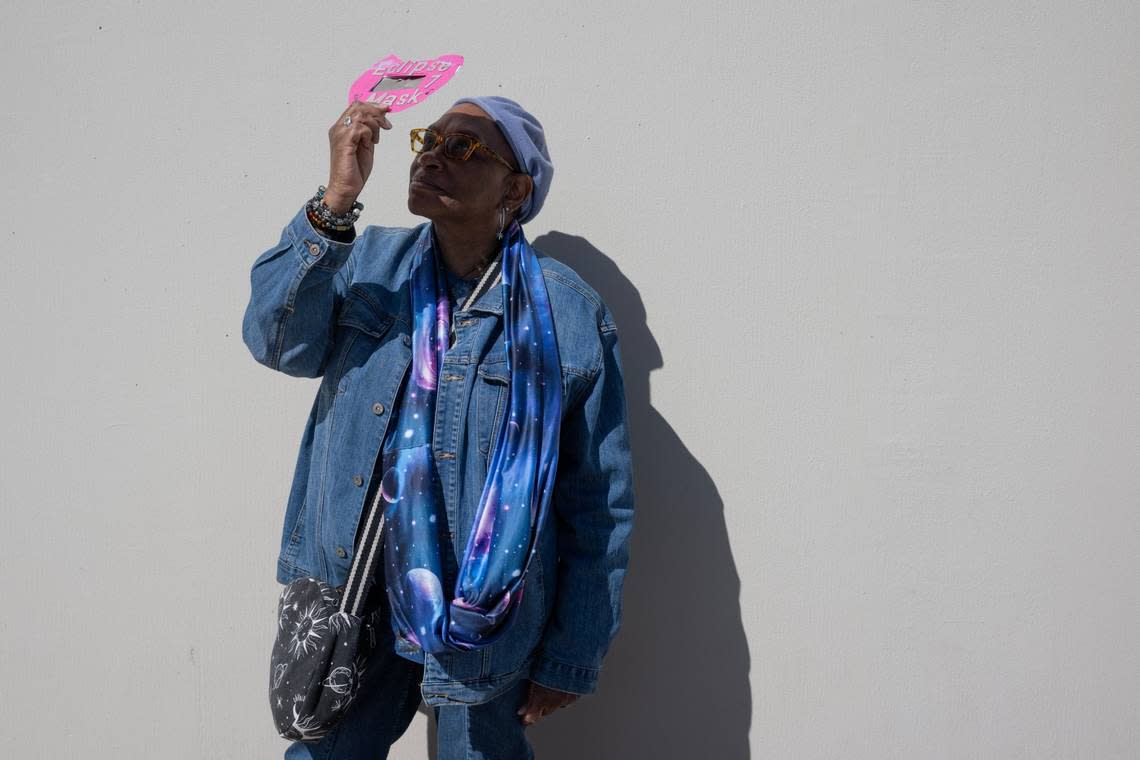 Beatrice Hagg of West Sacramento looks at the solar eclipse at the Museum of Science and Curiosity in Sacramento on Monday, April 8, 2024, with a viewer she made for the 2017 eclipse. She is wearing science-inspired clothing and said she has been interested in astronomy since she was a child.