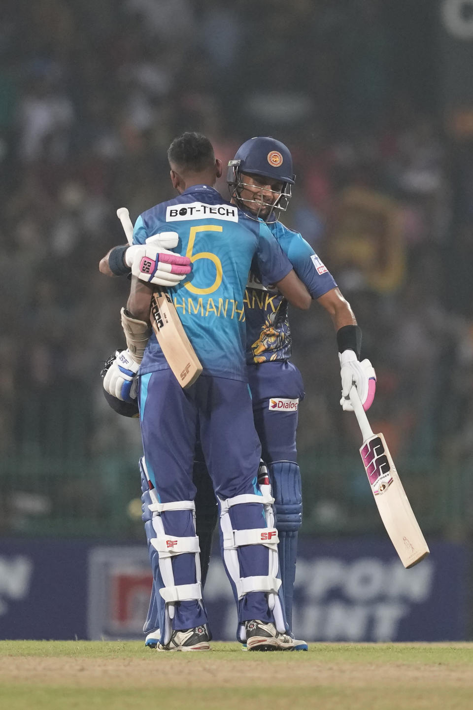 Sri Lanka's Dasun Shanaka and Dushmantha Chameera celebrate after completing the winning run in the first Twenty20 cricket match between Sri Lanka and Zimbabwe in Colombo, Sri Lanka, Sunday, Jan. 14, 2024. (AP Photo/Eranga Jayawardena)