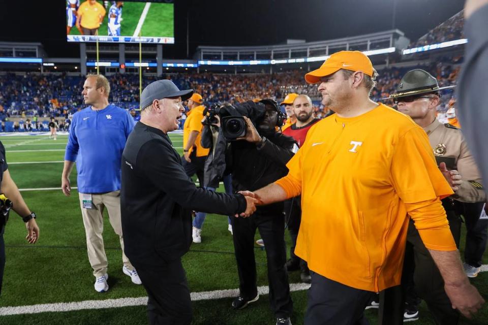 Kentucky coach Mark Stoops, left, shakes hands with Tennessee coach Josh Heupel after Saturday’s game at Kroger Field. The Vols won for the third straight time in Lexington.