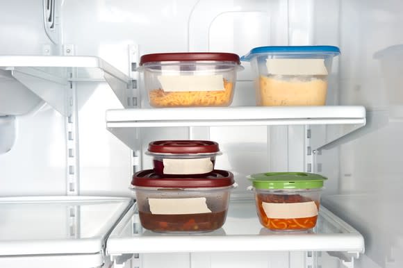 Some tupperware containers in a refrigerator.