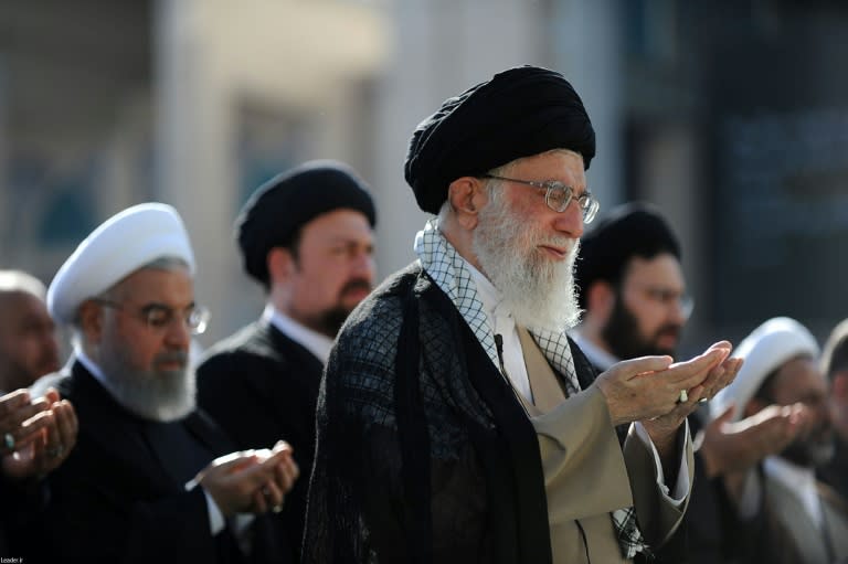 Iran's supreme leader Ayatollah Ali Khamenei (C) leads prayers near President Hassan Rouhani at the Imam Khomeini grand mosque in the capital Tehran