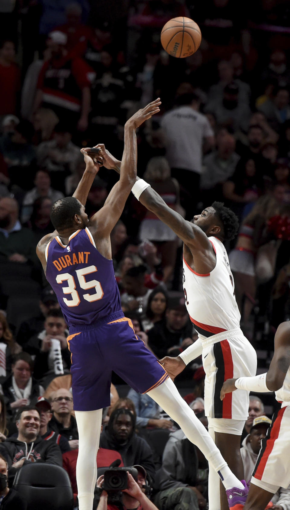 Phoenix Suns forward Kevin Durant, left, shoots over Portland Trail Blazers center Deandre Ayton during the second half of an NBA basketball game in Portland, Ore., Tuesday, Dec. 19, 2023. The Blazers won 109-104. (AP Photo/Steve Dykes)