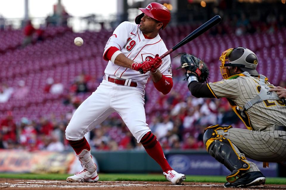 Cincinnati Reds first baseman Joey Votto (19) avoids a pitch during the first inning of a baseball game against the San Diego Padres, Wednesday, April 27, 2022, at Great American Ball Park in Cincinnati.