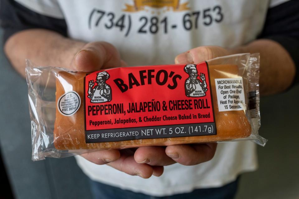 Stefano Raimonda, 55, holds a pepperoni, jalapeno and cheddar-cheese-roll-type sandwich inside the Baffo's Enterprises Inc. bakery in Riverview on Wednesday, March 6, 2024. Raimonda is the oldest son of the family-owned business that has been serving roll-type sandwiches for more than 25 years.