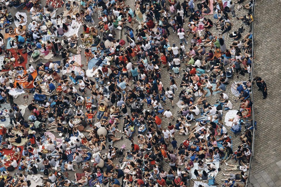 FILE - People gather to watch the fireworks display over the East River during Fourth of July celebrations on July 4, 2017, in the Queens borough of New York. Thirty percent of Americans don't identify with a religious group — but not all of them are atheists or agnostics. In fact, 43% of the group known as the "nones" say they believe in God, even if they largely dislike organized religion. (AP Photo/Andres Kudacki, File)