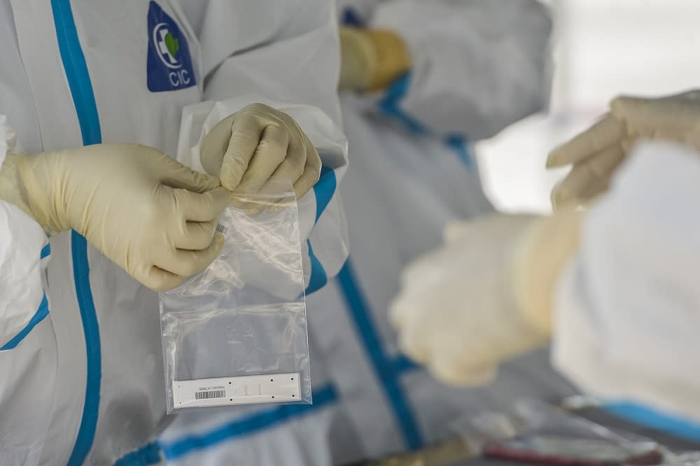 Health workers test members of the public for Covid-19 at Dewan MBSA Seksyen 19 in Shah Alam February 17, 2021. — Picture by Miera Zulyana