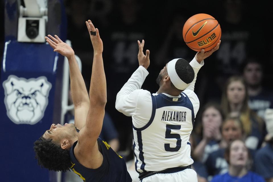 Butler's Posh Alexander (5) shoots over Marquette's Stevie Mitchell during the second half of an NCAA college basketball game Tuesday, Feb. 13, 2024, in Indianapolis. (AP Photo/Darron Cummings)