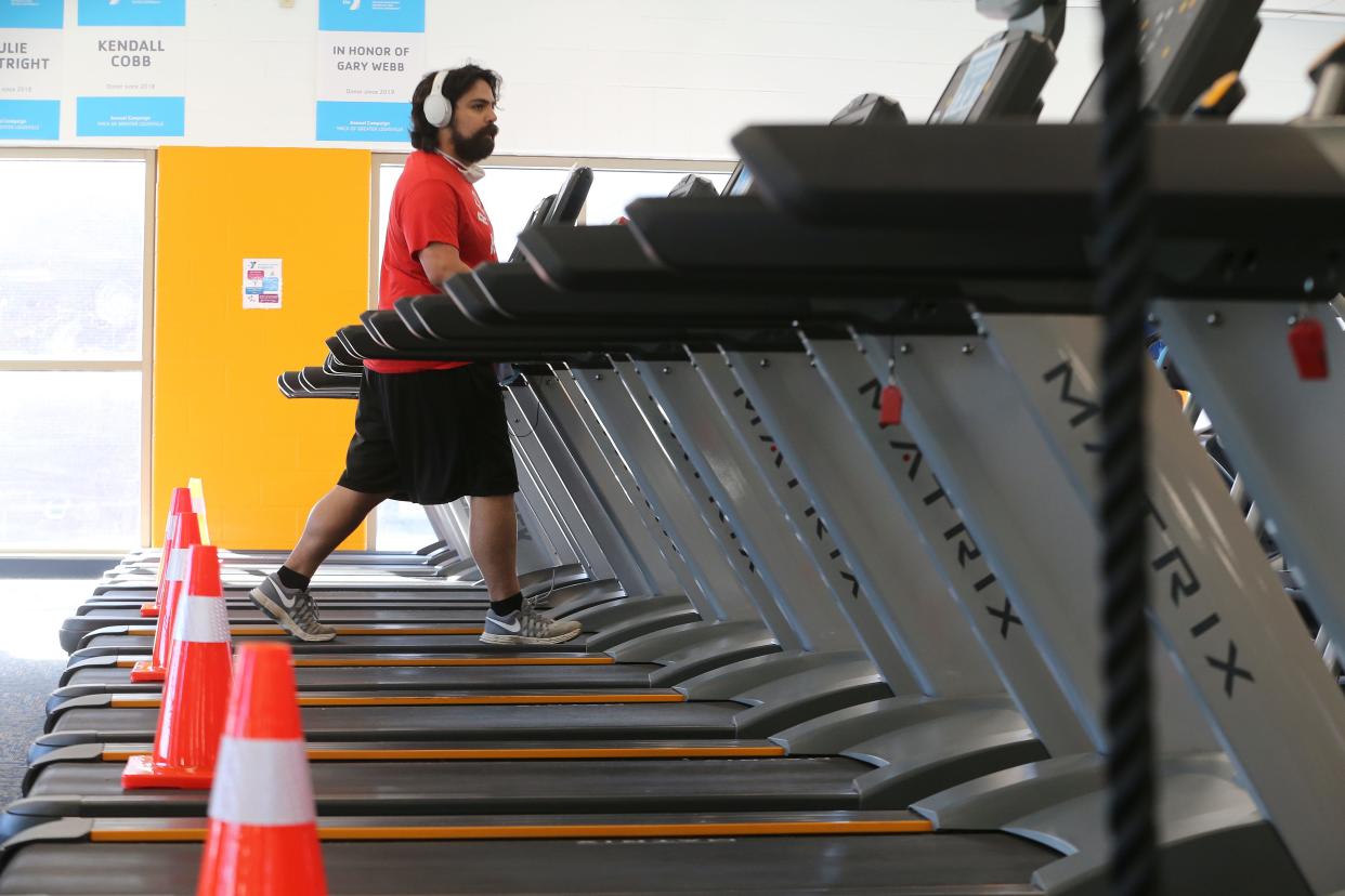 Sean Villanueva works out on a treadmill at the downtown YMCA on Monday, June 1, 2020.  Cones were placed on every other treadmill to create social distancing.  Gyms were allowed to reopen on Monday with increased social distancing and increased sanitation procedures.