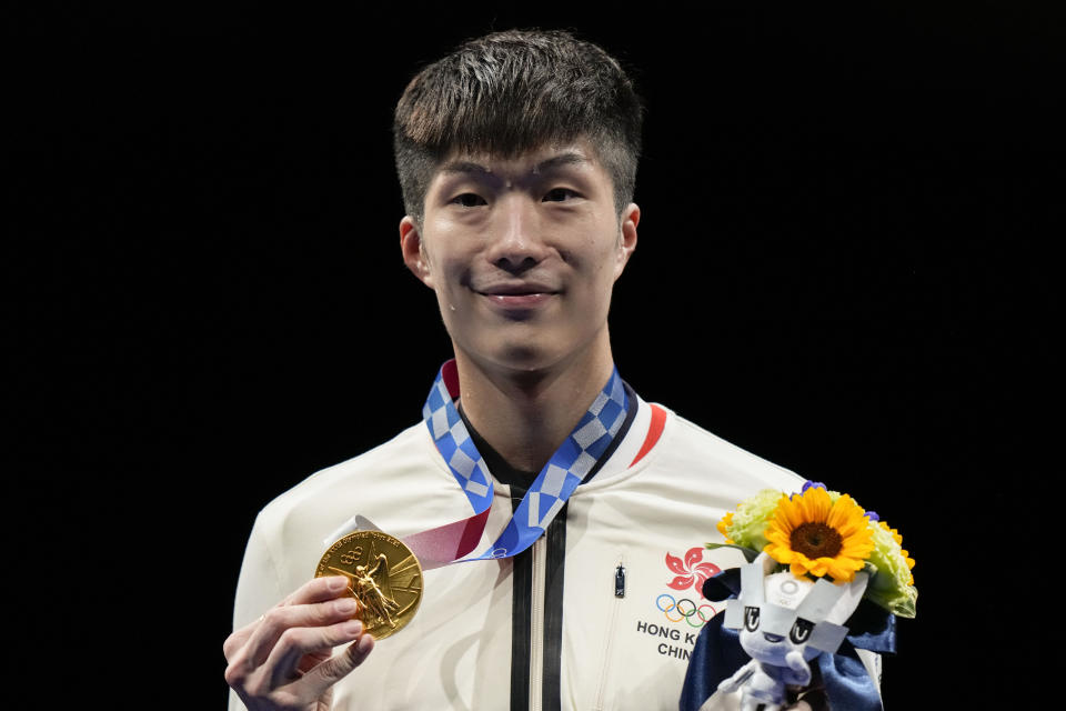 Ka Long Cheung of Hong Kong holds the gold medal during the awarding ceremony of the men's individual Foil competition at the 2020 Summer Olympics, Monday, July 26, 2021, in Chiba, Japan. (AP Photo/Andrew Medichini)