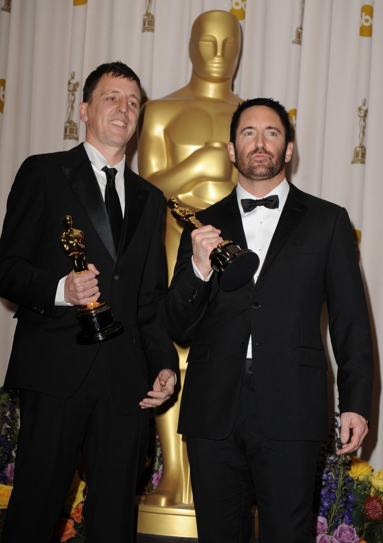 HOLLYWOOD, CA - FEBRUARY 27: Composers Atticus Ross (L) and Trent Reznor pose in the press room during the 83rd Annual Academy Awards held at the Kodak Theatre on February 27, 2011 in Hollywood, California. (Photo by Steve Granitz/WireImage)