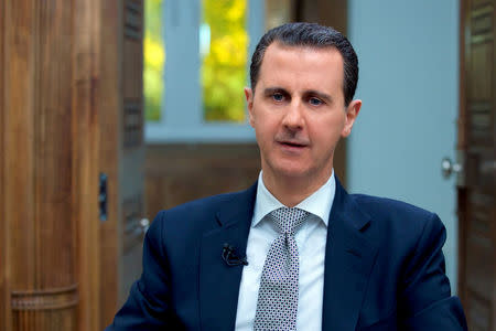 FILE PHOTO: Syria's President Bashar al-Assad speaks during an interview with AFP news agency in Damascus, Syria in this handout picture provided by SANA on April 13, 2017. SANA/Handout via REUTERS/File Photo