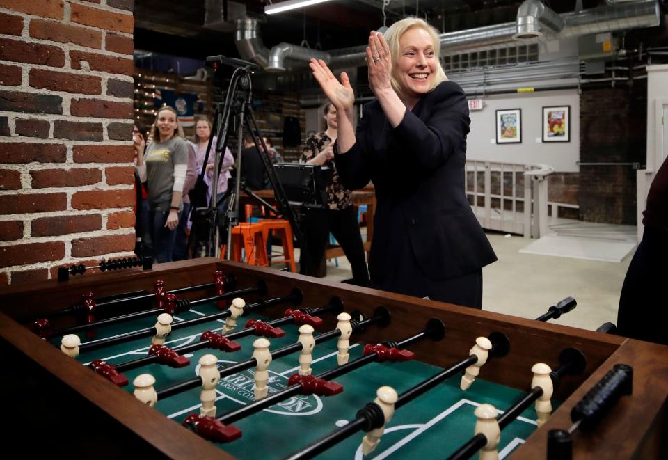 Democratic presidential candidate Sen. Kirsten Gillibrand, D-N.Y., celebrates her foosball victory at a campaign meet-and-greet, Friday, March 15, 2019, at To Share Brewing in Manchester, N.H.