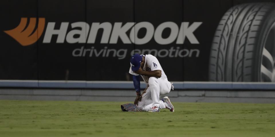 Los Angeles Dodgers’ Yasiel Puig reacts after diving for a ball hit by Houston Astros’ Alex Bregman during the eighth inning of Game 2 of baseball’s World Series Wednesday, Oct. 25, 2017, in Los Angeles. (AP Photo/David J. Phillip)