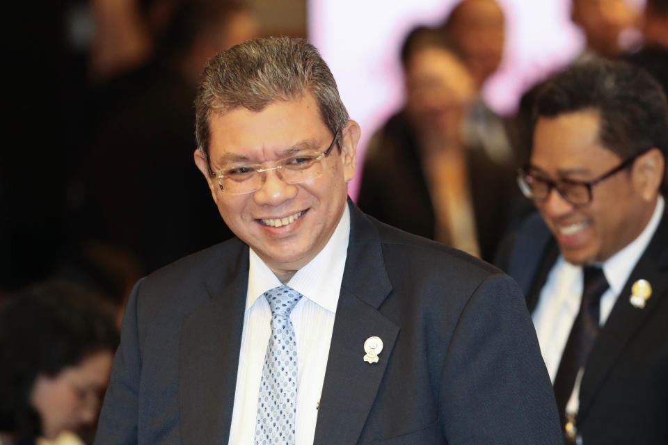 FILE - In this July 31, 2019, file photo, Malaysian Foreign Minister Saifuddin Abdullah smiles as he arrive for the ASEAN Foreign Ministers Meeting plenary session in Bangkok, Thailand. Saifuddin Abdullah said Saturday countries in the region are concerned about rising tensions over the growing numbers of warships plying the South China Sea.(AP Photo/Sakchai Lalit, File)