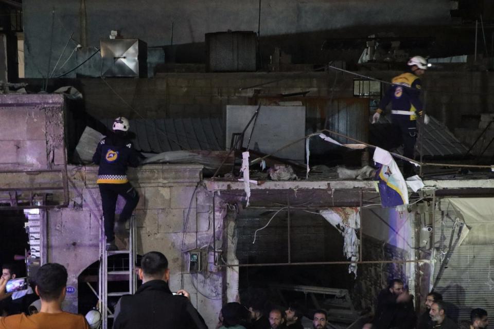 Volunteers of the Syria Civil Defence (White Helmets) work at the site of a car blast (via REUTERS)