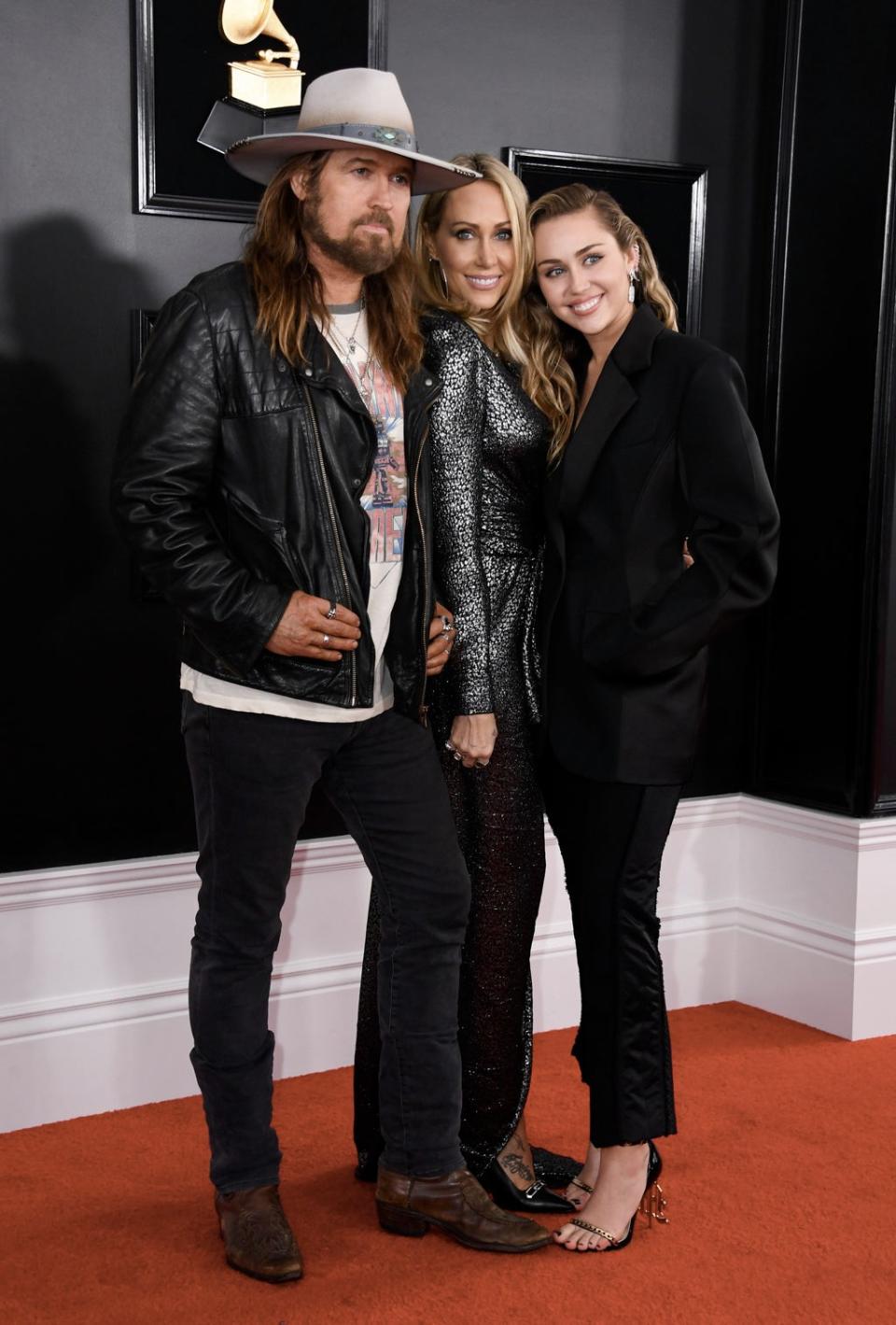 Singer Miley Cyrus (R) poses with her parents Billy Ray Cyrus and Tish Cyrus at the 61st Annual Grammy Awards in Los Angeles (AFP via Getty Images)