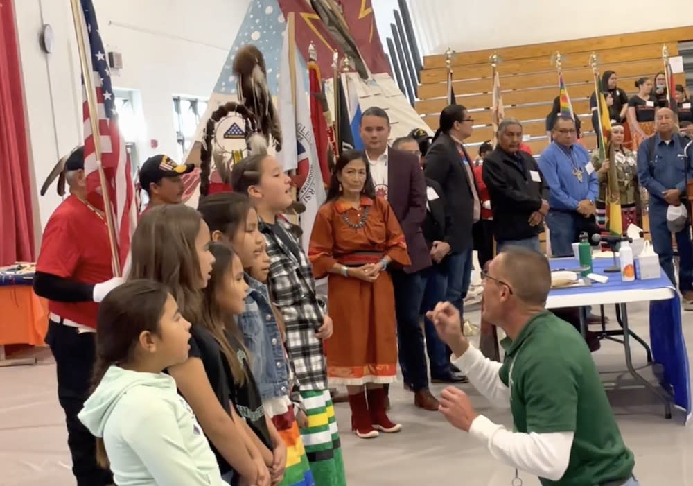 A choir of Native children sing as Interior Secretary Deb Haaland (center) and Assistant Secretary Indian Affairs Bryan Newland look during the October 2022 ‘Road to Healing’ event at the Rosebud Indian Reservation. (Photo:  Jenna Kunze) 