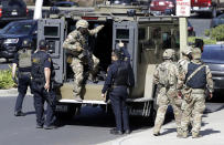 <p>Armed law enforcement personnel exit an armored vehicle outside YouTube headquarters, Tuesday, April 3, 2018, in San Bruno, Calif. A woman opened fire at YouTube headquarters Tuesday, setting off a panic among employees and wounding several people before fatally shooting herself, police and witnesses said. (Photo: Marcio Jose Sanchez/AP) </p>