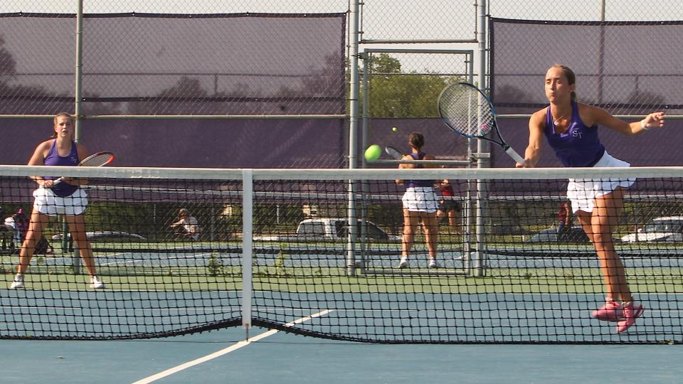Bloomington South's Riley Walker hits a return as Maddie Santner looks on during No. 1 doubles action against Bloomington North Friday, May 20, 2022 in the sectional finals.