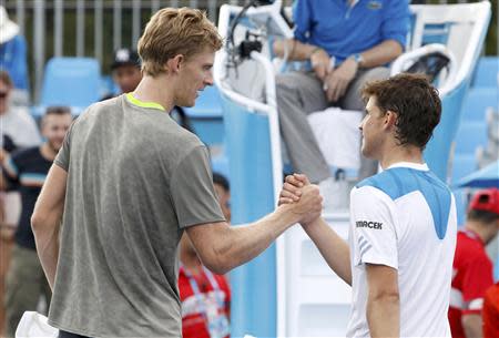 Kevin Anderson of South Africa (L) shakes hands with Dominic Thiem of Austria after defeating him in their men's singles match at the Australian Open 2014 tennis tournament in Melbourne January 15, 2014. REUTERS/Brandon Malone