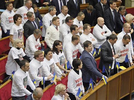 Opposition deputies wearing t-shirts in support of imprisoned former Ukrainian Prime Minister Yulia Tymoshenko react during a session of Parliament in Kiev November 13, 2013. REUTERS/Gleb Garanich